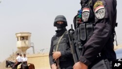 Egyptian policemen secure Egypt’s national police academy, where an Egyptian criminal court sentenced ousted Islamist President Mohammed Morsi and 12 Brotherhood leaders and Islamist supporters to 20 years in prison over the killing of protesters in 2012,