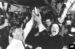 In this Wednesday March 2, 1989 file photo, Icelanders celebrate in a Reykjavik bar, as the first legal beer since 1915 went on sale in the Icelandic capital, which was banned following a referendum.