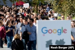 In this November 1, 2018, file photo, workers leave Google's Mountain View, California, main quad after some Google employees walked off the job in a protest against what they said is the tech company's mishandling of sexual misconduct allegations.
