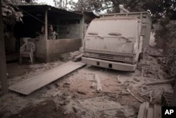 A truck is covered in volcanic ash spewed by volcano El Fuego, or Volcano of Fire, in Escuintla, Guatemala, June 4, 2018.
