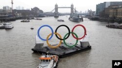 Backdropped by the historic Tower Bridge, a giant Olympic Rings floats on the River Thames in London in the run-up for the Olympic games, during its launch to mark 150-days until the start of the London 2012 Olympic games, February 28, 2012. 