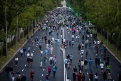 People exercise along Paseo de la Castellana after the lockdown measures due to coronavirus in Madrid, Spain, May 9, 2020.