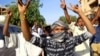 FILE - Demonstrators chant slogans as they march along the street during anti-government protests in Khartoum, Sudan, Dec. 25, 2018. 