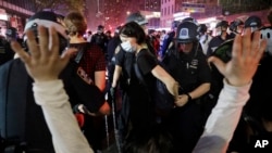 Police arrest protesters as they march through the streets of Manhattan, New York, June 3, 2020.