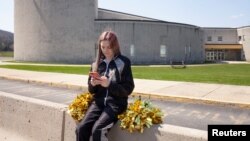 Brandi Levy poses outside of her high school in Pennsylvania. She tried out for the cheerleading team a number of years ago, prompting a social media post that will now be discussed by the U.S. Supreme Court. (Danna Singer/Handout via REUTERS)