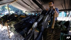 FILE - Weapons belonging to rebels of the Revolutionary Armed Forces of Colombia (FARC) are stored at a rebel camp in La Carmelita near Puerto Asis in Colombia's southwestern state of Putumayo.