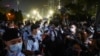 People look at police officers standing guard at Victoria Park on the 32nd anniversary of the crackdown on pro-democracy demonstrators at Beijing's Tiananmen Square in 1989, in Hong Kong, June 4, 2021. 