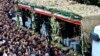 En esta foto facilitada por la agencia de noticias Fars, iraníes acompañan a un camión que transporta los ataúdes del presidente iraní, Ebrahim Raisi, y de otros funcionarios que murieron tras la caída de su helicóptero en el noroeste del país. En Tabriz, 21 de mayo de 2024.