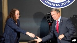 FILE - Nebraska 2nd District Rep. Don Bacon, a Republican and his challenger Democrat Kara Eastman break away from a handshake following a debate in Omaha, Nebraska, Oct. 18, 2018.