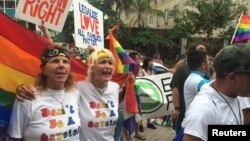 A Bangladeshi man, with his face painted in the colors of the national flag, takes part in a rally to mark the country's 44th Victory Day in Dhaka.