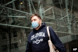 A student walks on the Columbia University campus in New York. (AP Photo/John Minchillo)