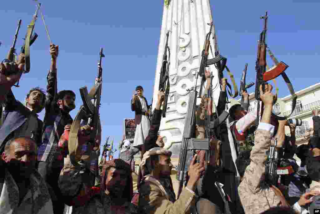 Shiite rebels, known as Houthis, hold their weapons in the air during a demonstration against an arms embargo imposed by the U.N. Security Council on Houthi leaders, in Sana'a, April 16, 2015.