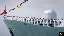 FILE - China's frigate Huangshan is seen anchored in the waters off RSS Singapura Changi Naval Base, May 15, 2017, in Singapore. 