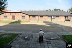Pope Francis prays during his visit to the former Nazi German death camp of Auschwitz-Birkenau in Oswiecim, Poland, July 29, 2016.