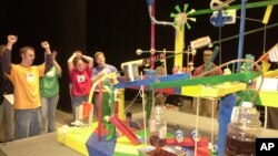 Members of the Theta Tau-Phi Sigma Rho team react to a successful run of their People's Choice Award winning entry in the Rube Goldberg Machine Contest Saturday, Feb. 9, 2002 in West Lafayette, Indiana. (AP Photo/Dave Umberger)