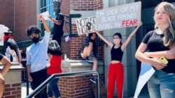 Natasha Dhamavasi (second from right), Archawee Dhamavasi's daughter, holds a banner during a Black Lives Matter protest in Downers Grove village, Illinois on June 7, 2020