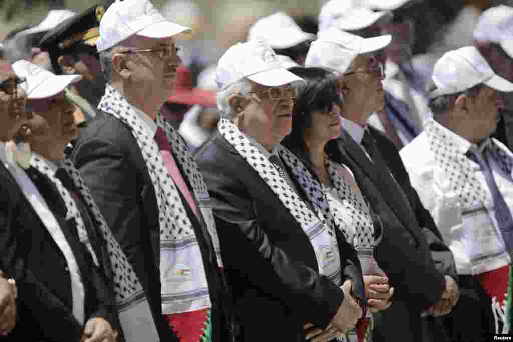 Palestinian President Mahmoud Abbas (C) attends an open-air mass led by Pope Francis in the Manger Square, next to the Nativity Church in the West Bank town of Bethlehem.