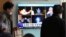People watch a TV screen showing a local news program reporting about North Korea's missile launch, at the Seoul Railway Station in Seoul, South Korea, Nov. 30, 2017. 