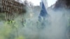 Demonstrators, called the yellow jackets, holds up an EU flag during a protest against rising fuel prices in Brussels, Friday, Nov. 30, 2018.