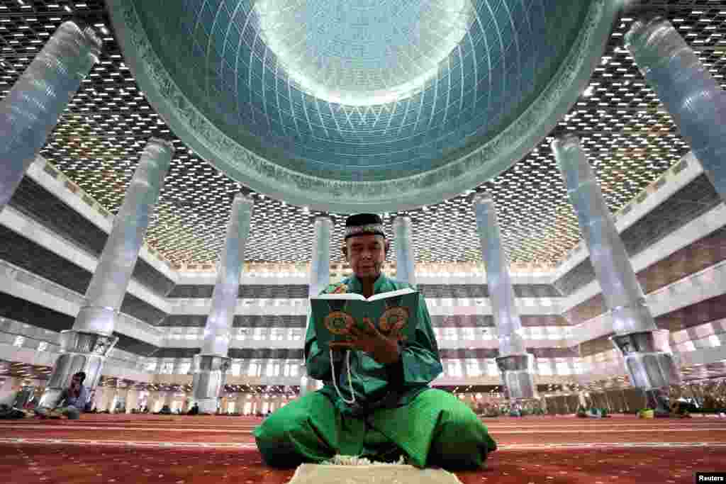 A Muslim man reads the Koran at the Great Mosque of Istiqlal during the holy fasting month of Ramadan in Jakarta, Indonesia.