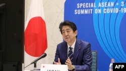 In this handout photograph received by Jiji Press and released by Japan's Cabinet Public Relations Office, Japan's Prime Minister Shinzo Abe speaks from Tokyo with other Asean leaders during a video conference on April 14, 2020. - Leaders of Japan,…