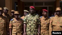 Lieutenant Colonel Yacouba Isaac Zida (C) poses for a picture after a news conference in which he was named president at the military headquarters in Ouagadougou, capital of Burkina Faso, November 1, 2014. Burkina Faso's military backed the presidential g