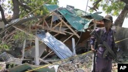 A Somalia soldier stands guard near the destroyed restaurant in Mogadishu, Somalia, Dec. 15, 2016.