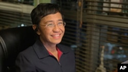 In this photo provided by the Rappler, Rappler CEO and Executive Editor Maria Ressa reacts after hearing she won the Nobel Peace Prize, inside her home in Taguig, Metro Manila, Philippines, Oct. 8, 2021.