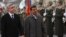 Armenian President Serzh Sargsyan (L) walks with Iran's President Mahmoud Ahmadinejad (C) during an official welcoming ceremony in Yerevan, Dec. 23, 2011. 
