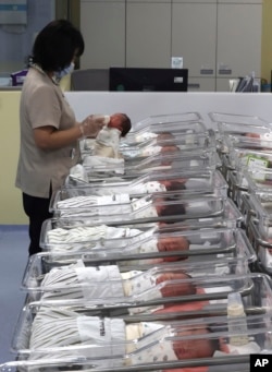 A nurse takes care of a newborn baby in a neonatal room of a hospital in Incheon, South Korea, Wednesday, Feb. 26, 2025. (Jeon Jin-hwan/Newsis via AP)