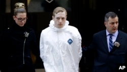 James Harris Jackson is escorted out of a police precinct in New York, March 22, 2017. 