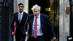Aliyekuwa waziri mkuu wa Uingereza Boris Johnson akiwa na Rishi Sunak wakitoka Ofisini Downing street kwa kikao cha baraza la mawaziri Sept 1 2020. Sunak na Boris wanamenyana kuwa waziri mkuu mpya wa Uingereza