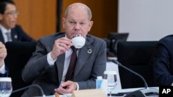 Канцлер Німеччини Олаф Шольц п’є каву або чай з іншими лідерами G7 під час саміту у Хіросімі, Японія, 20 травня 2023 р. AP Photo/Susan Walsh