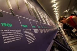 FILE - Guests attend the opening of the 'Stonewall 50' exhibit, commemorating the 50th anniversary of the Stonewall uprising and the dawn of the gay liberation movement, at the New Historical Society, in New York City, May 22, 2019.