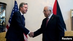 El secretario de Estado de EEUU, Antony Blinken, estrecha la mano del presidente palestino, Mahmoud Abbas, en Ammán, Jordania, el 13 de octubre de 2023.