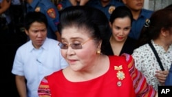  FILE - Former Philippines first lady, Congresswoman Imelda Marcos arrives at the Commission on Elections to support her daughter, Gov. Imee Marcos in filing for the May 2019 midterm elections in Manila, Philippines.