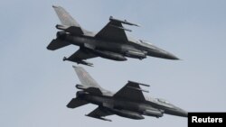 Polish Air Force F-16 fighter jets fly in formation during the Clear Sky 2018 multinational military..