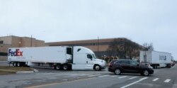 A FedEx truck leaves the Pfizer Global Supply manufacturing plant with a small convoy, amid the coronavirus disease (COVID-19) outbreak, in Portage, Michigan, U.S., December 13, 2020. REUTERS/Rebecca Cook