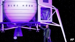Jeff Bezos speaks in front of a model of Blue Origin's Blue Moon lunar lander, Thursday, May 9, 2019, in Washington. (AP Photo/Patrick Semansky)
