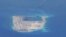 FILE - Chinese dredging vessels are purportedly seen around Fiery Cross Reef in the disputed Spratly Islands in the South China Sea in this image from video taken by a P-8A Poseidon surveillance aircraft provided by the U.S. Navy, May 21, 2015. 