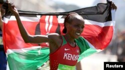 Jemima Sumgong (KEN) of Kenya celebrates after winning the Women's Marathon, Aug. 14, 2016. 