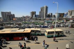 People walk through Megenagna neighborhood bus station in Addis Ababa, Ethiopia November 3, 2021. REUTERS/Tiksa Negeri
