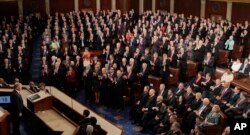 Republicans Congressional members stand and applaud as Democratic members sit as President Donald Trump pauses during his address to a joint session of Congress on Capitol Hill in Washington, Tuesday, Feb. 28, 2017. (AP Photo/J. Scott Applewhite)