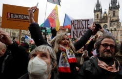 A demonstrator gestures as she attends a protest against the Czech government's restrictions, as the spread of the coronavirus disease (COVID-19) continues, at the Old Town Square in Prague, Czech Republic January 10, 2021. REUTERS/David W Cerny
