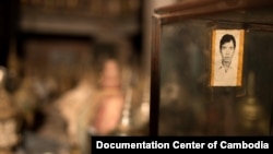 An unidentified picture is seen hanging in from of over 100 cremation urns at public vault at Phnom Penh’s Wat Lanka, Sunday, February 1, 2015. The urns are believed to have been left from Cambodia’s chaotic war period of the 1970s and have yet to be pick