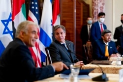 Secretary of State Antony Blinken, Israeli Foreign Minister Yair Lapid, left, and United Arab Emirates Foreign Minister Sheikh Abdullah bin Zayed al-Nahyanin, right, appear at a joint news conference at the State Department in Washington, Oct. 13, 2021.