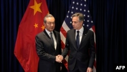 US Secretary of State Antony Blinken (R) shakes hands with Director of the Office of the Foreign Affairs Commission of the Communist Party of China's Central Committee Wang Yi during their bilateral meeting on the sidelines of the Association of Southeast
