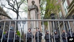 Policías hacen guardia afuera de la Universidad de Columbia después de despejar el campus de manifestantes, mientras las tensiones en los campus universitarios de EEUU crecen por la guerra en Gaza, el 18 de abril de 2024, en Nueva York.
