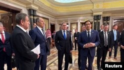 ԱՄՆ պետքարտուղար Մարկո Ռուբիոն և Ռուսաստանի արտգործնախարար Սերգեյ Լավրովը՝ ամերիկյան ու ռուսական պատվիրակությունների անդամների հետ։ Էր-Ռիադ, փետրվարի 18, 2025թ․։