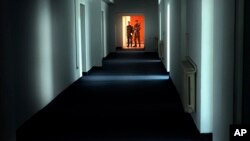 FILE - Romanian military staff stand at the end of a corridor on the Mihail Kogalniceanu airbase, near the Black Sea port of Constanta, Nov. 9, 2005. The Soviet-era facility became a key focus of a European investigation into allegations that the CIA operated secret prison on the site.